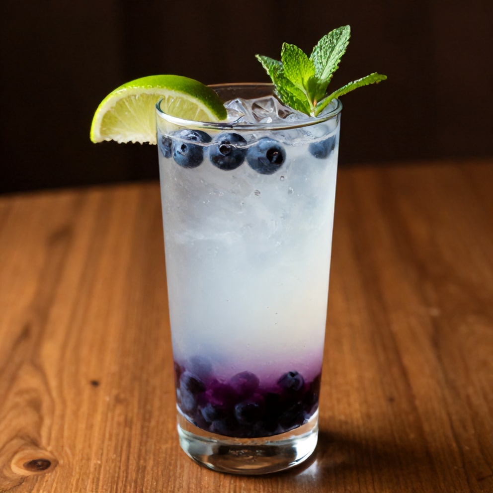 Blueberry Coconut Water Drink garnished with lime and mint
