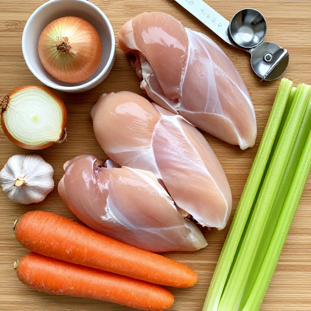 Raw ingredients for Southwest Chicken Soup on a wooden surface