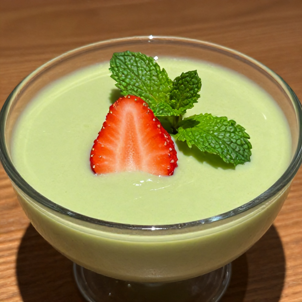Plated strawberry matcha sago dessert with a mint leaf garnish