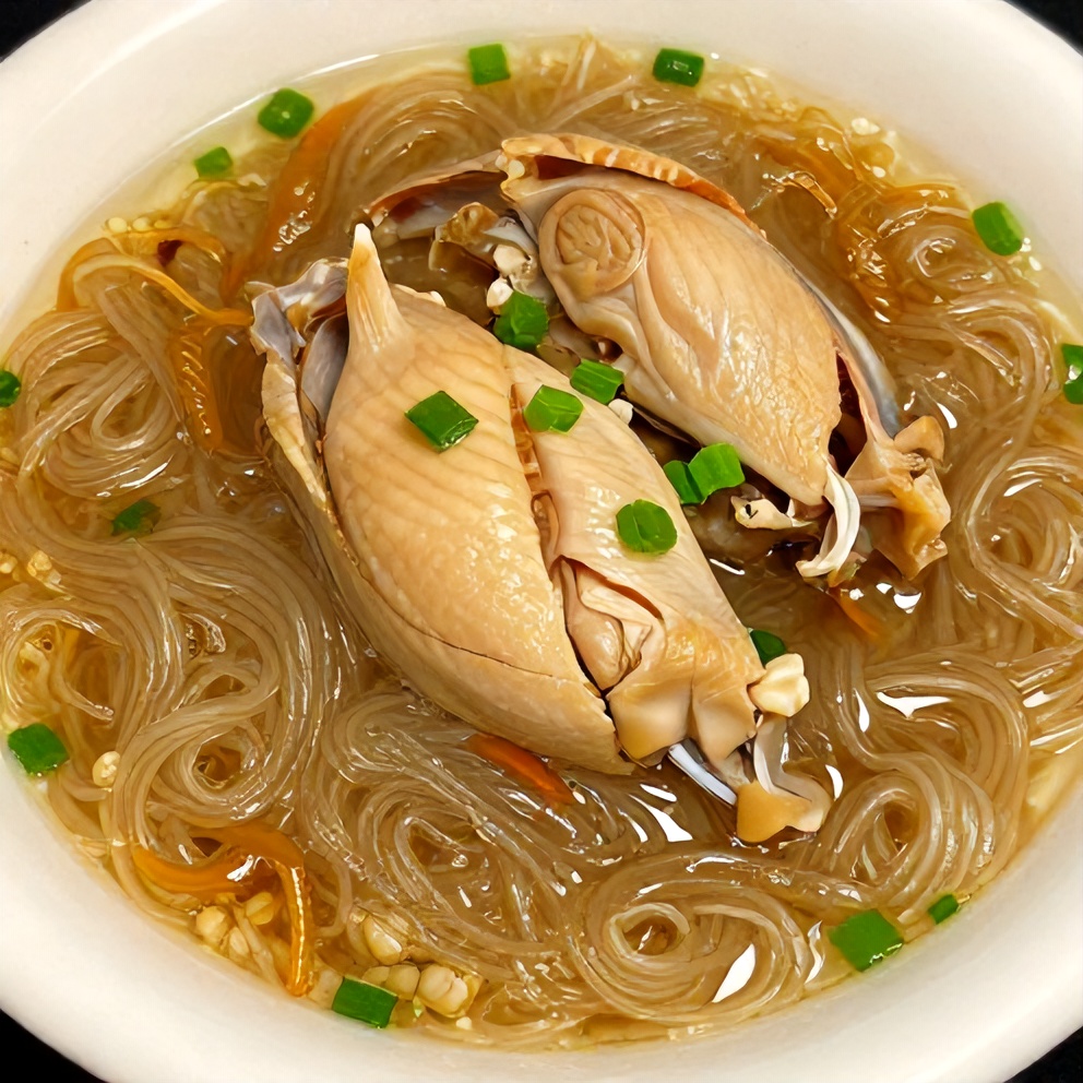 Bowl of Ginger Scallion Chicken Noodle Soup, garnished with green onions